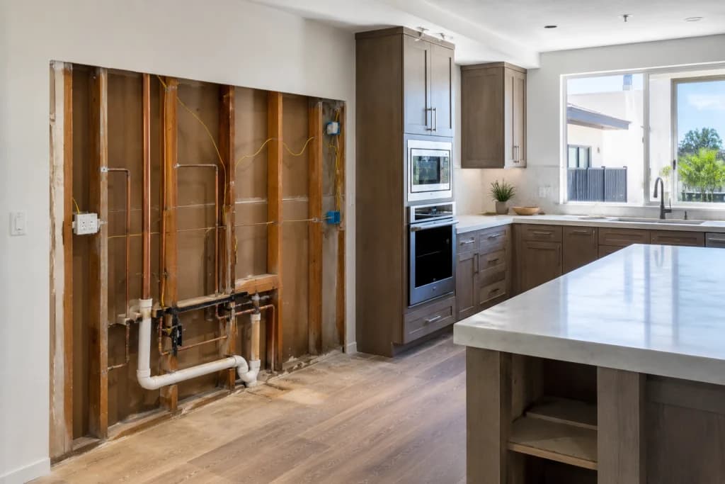 Kitchen renovation with visible plumbing and electrical work