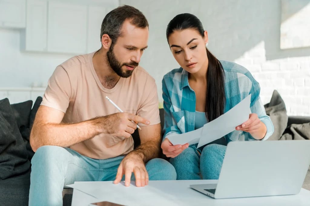 crello 226760648 stock photo serious couple sitting couch filling 2500x1668 1